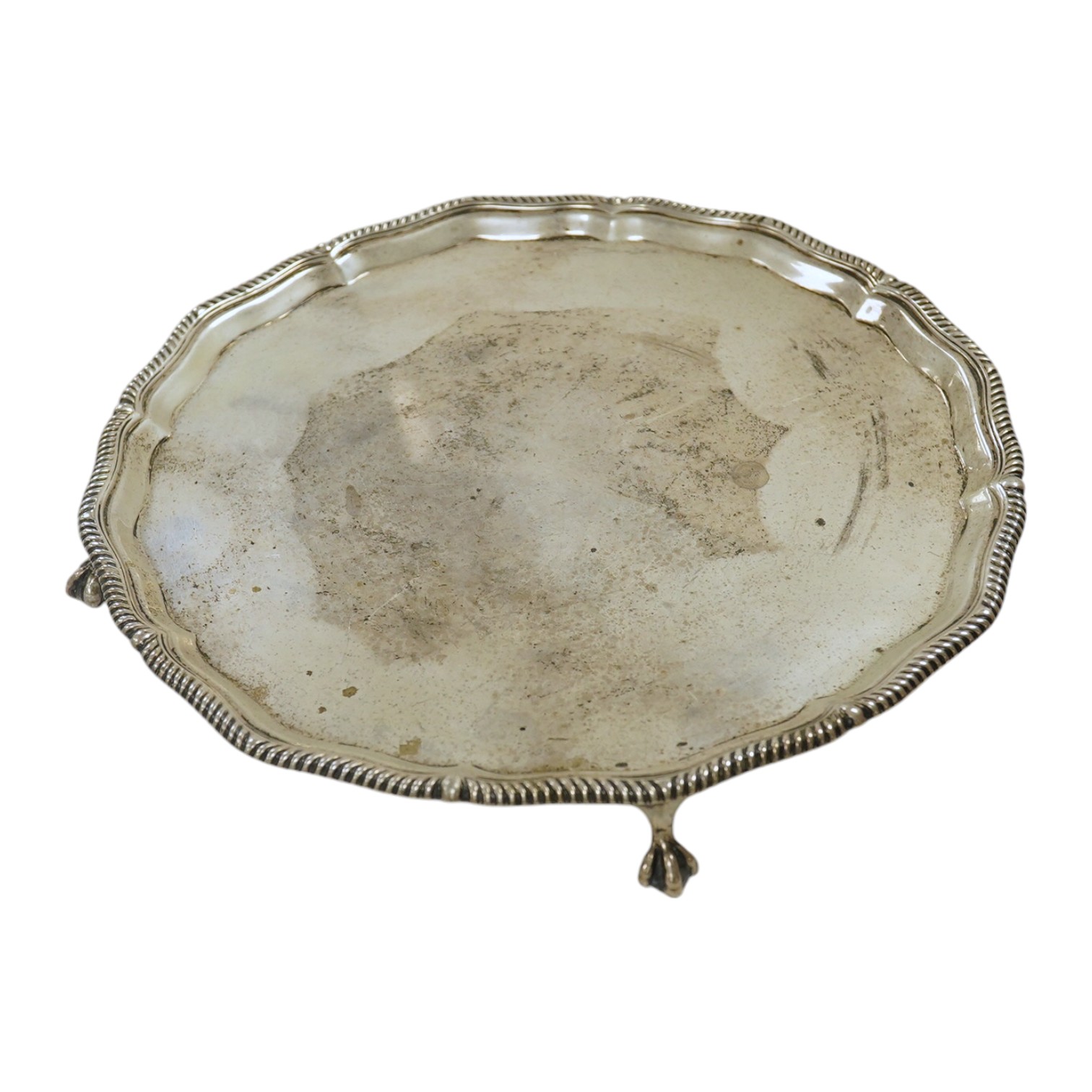 An Edwardian silver salver by Thomas Bradbury & Sons, London, 1903, on four claw and ball feet, 17.9oz. Condition - fair